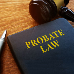 Probate law book and gavel on wooden table, legal concept image.